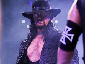 The Undertaker stares across the ring to his opponent, Triple H.