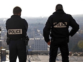 Two policemen stand guard near the Sacre Coeur basilica in Montmartre area in Paris on November 26, 2020.