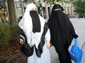 Zaynab Khadr (in black) is pictured in this Oct. 6, 2009 file photo taken in downtown Toronto.