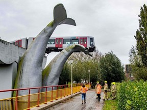 A Dutch metro train was saved from disaster when it smashed through a safety barrier but was prevented from plummeting into water by a sculpture of a whale tail, in Spijkenisse, near the port city of Rotterdam, early Monday, Nov. 2, 2020.