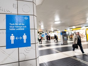 A sign reminding people to respect social distancing is seen at the Central Station in Stockholm, Sweden November 9, 2020.