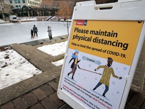 With public skating now open at Calgary's Olympic Plaza on Wednesday, November 18, 2020, a sign reminds skaters on the ice they need to be hockey stick length apart to avoid being too close to others.