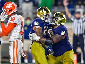Notre Dame Fighting Irish running back Kyren Williams celebrates with offensive lineman Aaron Banks after scoring the game-winning touchdown in second overtime against the Clemson Tigers at Notre Dame Stadium in South Bend, Ind., on Nov. 7, 2020.