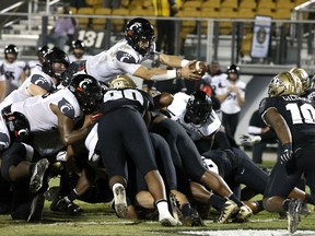 Cincinnati Bearcats quarterback Desmond Ridder dives over the top for a touchdown against the UCF Knights at the Bounce House in Orlando, Fla., on Nov. 21, 2020.