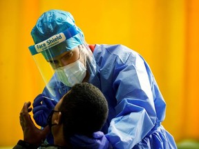 A healthcare worker performs a rapid COVID-19 antigen test amid the coronavirus disease (COVID-19) outbreak in Alpedrete, Spain, November 16, 2020.