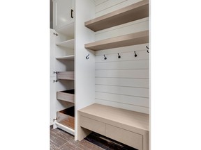This linen closet, by  Rockwood Custom Homes, includes drawers and open shelves to help sort and store items.