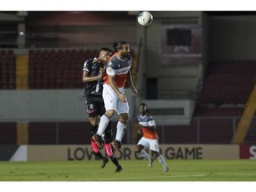 Forge FC forward Mo Babouli (right) heads the ball in front of a Tauro FC defender during a Scotiabank CONCACAF League round-of-16 match in Panama City on Tuesday in this handout photo. Photo courtesy CONCACAF.com/Special to Postmedia.