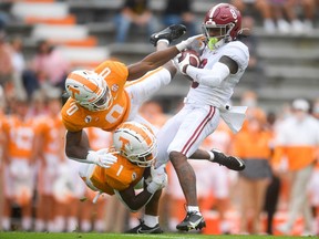 Tennessee defensive backs Bryce Thompson (0) and Trevon Flowers tackle Alabama wide receiver John Metchie at Neyland Stadium in Knoxville, Tenn., on Oct. 24, 2020.