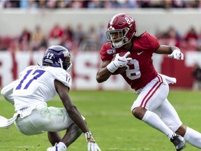 Alabama wide receiver John Metchie (8) runs a pass reception against Western Carolina defensive back Reggie Jones (17) during the first half of an NCAA college football game, Saturday, Nov. 23, 2019, in Tuscaloosa, Ala.
