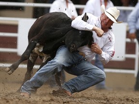 Curtis Cassidy of Donalda, Alta., competes in steer wrestling during the Calgary Stampede on July 15, 2017.