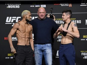 Deiveson Figueiredo (left) and Brandon Moren face off during the UFC 256 weigh-in at UFC APEX in Las Vegas on Dec. 11, 2020.