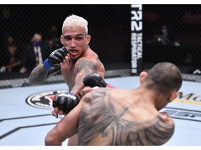 Charles Oliveira of Brazil punches Tony Ferguson in their lightweight bout during the UFC 256 event at UFC APEX on December 12, 2020 in Las Vegas, Nevada.