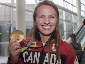 CALGARY, AB -- Rio Olympic gold medal wrestler Erica Wiebe returns to Calgary and is greeted by family, friends and fans at the Air Canada arrivals terminal, on August 26, 2016. Postmedia file