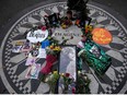 Picturs are seen on a monument as mourners gather on the 40th anniversary of John Lennon's death, at Strawberry Fields, in Central Park to honor the late Beatles star in New York on December 8, 2020.