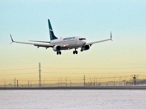 A WestJet Boeing 737 lands at the Calgary International Airport on Tuesday, Dec.15, 2020.