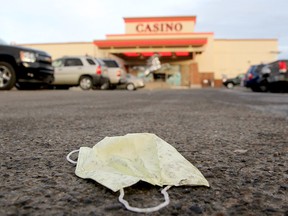 A discarded mask in the parking lot of Deerfoot Casino. Tuesday, Dec. 8, 2020.
