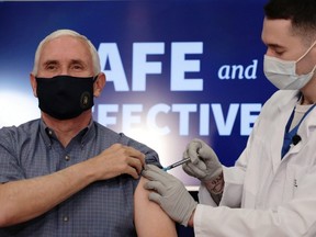 U.S. Vice President Mike Pence receives the COVID-19 vaccine at the White House in Washington, D.C., Friday, Dec. 18, 2020.