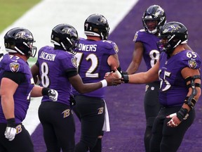 Ravens quarterback Lamar Jackson (8) celebrates with teammates following a 5-yard touchdown run during the third quarter of their game against the Jaguars at M&T Bank Stadium in Baltimore, Dec. 20, 2020.