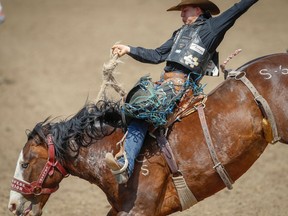 Zeke Thurston of Big Valley, Alta., rides Stampede Warrior during the saddle bronc competition at the 2018 Calgary Stampede.