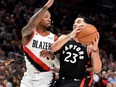 Raptors guard Fred VanVleet (right) drives to the basket against Trail Blazers guard Damian Lillard (left) during NBA action at the Moda Center in Portland, Oregon, Nov. 13, 2019.