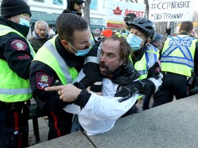 Calgary police and ptotestors clash during the anti-mask rally at City Hall in Calgary on Saturday, December 19, 2020. Darren Makowichuk/Postmedia