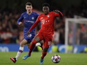 Bayern's Alphonso Davies, right, is challenged by Chelsea's Mason Mount during a first leg, round of 16, Champions League soccer match between Chelsea and Bayern Munich at Stamford Bridge Stadium in London, England, on Feb. 25, 2020.