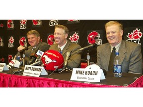 Calgary Stampeders general manager and head coach Matt Dunigan (centre) welcomes new secondary coach Mike Roach and defensive co-ordinator Denny Creehan to the team at a press conference at McMahon Stadium in Calgary in January 2004.