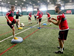 Cavalry FC’s Nik Ledgerwood (left) and Sergio Camargo exercise during training camp at the Macron Performance Centre in Calgary on March 2, 2020.