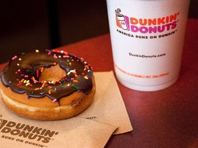 A chocolate glazed donut and a cup of coffee from Dunkin' Donuts photographed on Thursday, July 7, 2011.