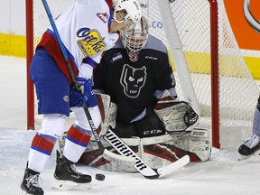 Calgary Hitmen goaltender Jack McNaughton battles the Edmonton Oil Kings’ Jake Neighbours at the Scotiabank Saddledome in Calgary on Dec. 30, 2019.