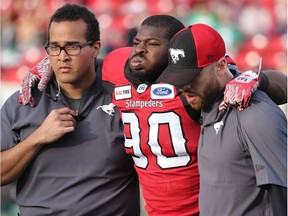 Calgary Stampeders defensive lineman Folarin Orimolade is helped off the field after being injured during pre-season CFL action against the Saskatchwan Roughriders at McMahon Stadium in Calgary on Friday May 31, 2019. Gavin Young/Postmedia