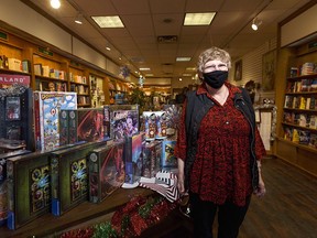 Susan Hare, owner of Owl’s Nest Books, poses for a photo on Friday, Dec. 11, 2020.