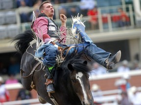 Orin Larsen, of Inglis, Man., rides Mulberry Hill during the Calgary Stampede bareback event on July 11, 2019.