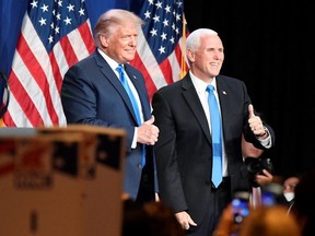 U.S. President Donald Trump and Vice President Mike Pence react at the Republican National Convention in Charlotte, N.C., Aug. 24, 2020.