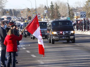 Hundreds of police and their families along with citizens lined the street at Memorial Drive and 68 Street to honour Sgt. Andrew Harnett during his funeral procession in Calgary on Tuesday, January 5, 2021. Darren Makowichuk/Postmedia