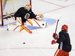 Jacob Markstrom make a save on a shot from Rasmus Andersson during Calgary Flames practice at the Saddledome on Friday, Jan. 15, 2021.