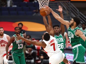 Boston Celtics forward Jayson Tatum blocks a shot by Toronto Raptors guard Kyle Lowry.