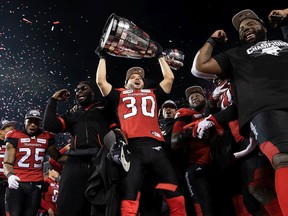 Calgary Stampeders placekicker Rene Paredes hoists the Grey Cup after their victory against the Ottawa Redblacks during the Grey Cup game at Commonwealth Stadium in Edmonton on Nov. 25, 2018.