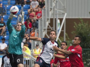 Goalkeeper Tyson Farago of FC Edmonton grabs the ball on a corner kick by the Indy Eleven, kicking off the fall NASL season in Edmonton on July 29, 2017.