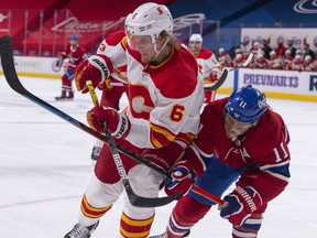 Juuso Valimaki of the Calgary Flames skates against Brendan Gallagher of the Montreal Canadiens during the second period at Bell Centre on Jan. 28, 2021 in Montreal.