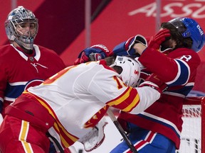 MONTREAL, QC - JANUARY 28:  Ben Chiarot #8 of the Montreal Canadiens and Matthew Tkachuk #19 of the Calgary Flames play rough during the third period at the Bell Centre on January 28, 2021 in Montreal, Canada.  The Montreal Canadiens defeated the Calgary Flames 4-2.
