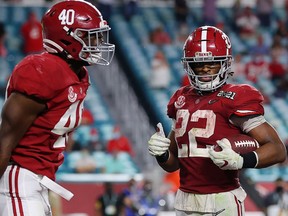 MIAMI GARDENS, FLORIDA - JANUARY 11: Najee Harris #22 of the Alabama Crimson Tide rushes for a one yard touchdown during the fourth quarter of the College Football Playoff National Championship game against the Ohio State Buckeyes at Hard Rock Stadium on January 11, 2021 in Miami Gardens, Florida.