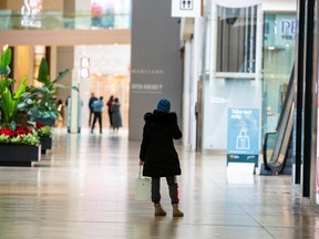 A woman speaks on the phone at Yorkdale Shopping Centre during a renewed coronavirus lockdown on Nov. 23, 2020.