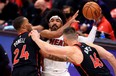 Miami Heat's Gabe Vincent is pressured by Raptors' Norman Powell and Aron Baynes during Friday's game.