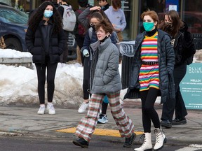 Calgarians wear masks while walking in the Beltline on Tuesday, Jan. 12, 2021.