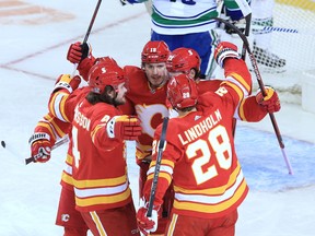 The Calgary Flames celebrate Sean Monahan’s first period goal on the Vancouver Canucks during the Calgary Flames NHL home opener on Saturday, January 16, 2021. 
Gavin Young/Postmedia