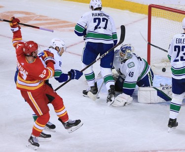 Sean Monahan scores on Vancouver Canucks goaltender Braden Holtby during the Calgary Flames NHL home opener on Saturday, January 16, 2021. 
Gavin Young/Postmedia