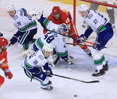 The Calgary Flames and Vancouver Canucks scramble in front of the Vancouver net during the Calgary Flames NHL home opener on Saturday, January 16, 2021. 
Gavin Young/Postmedia