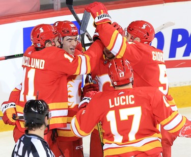 The Calgary Flames celebrate Dillon Dube’s goal on Vancouver Canucks goaltender Braden Holtby during the Calgary Flames NHL home opener on Saturday, January 16, 2021. 
Gavin Young/Postmedia