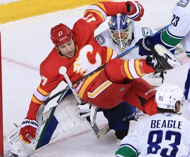 The Calgary Flames’ Milan Lucic collides with Vancouver Canucks goaltender Braden Holtby during the Calgary Flames NHL home opener on Saturday, January 16, 2021. 
Gavin Young/Postmedia